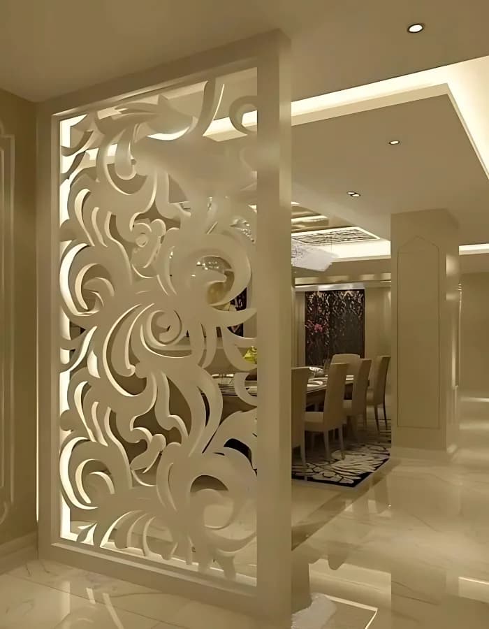 CNC-cut decorative jali partition dividing a dining space