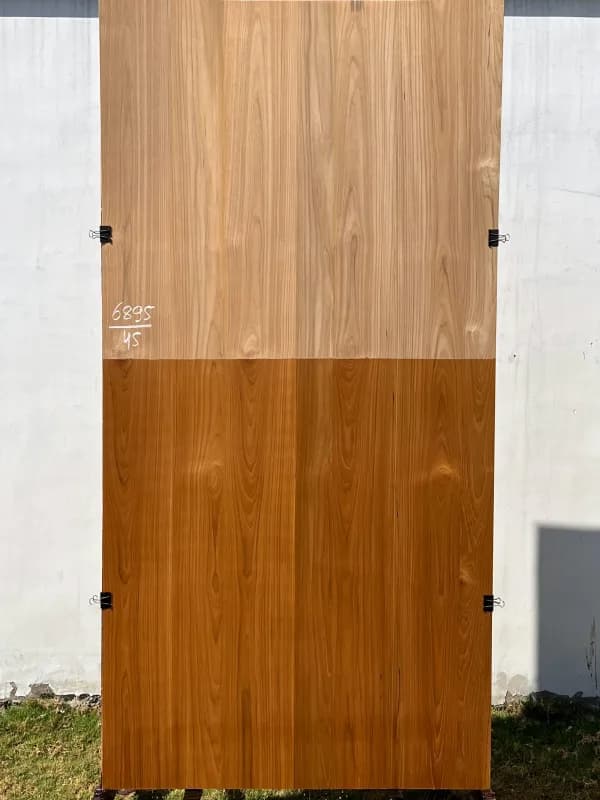 Teak veneer sheet with a raw upper half and a finished lower half