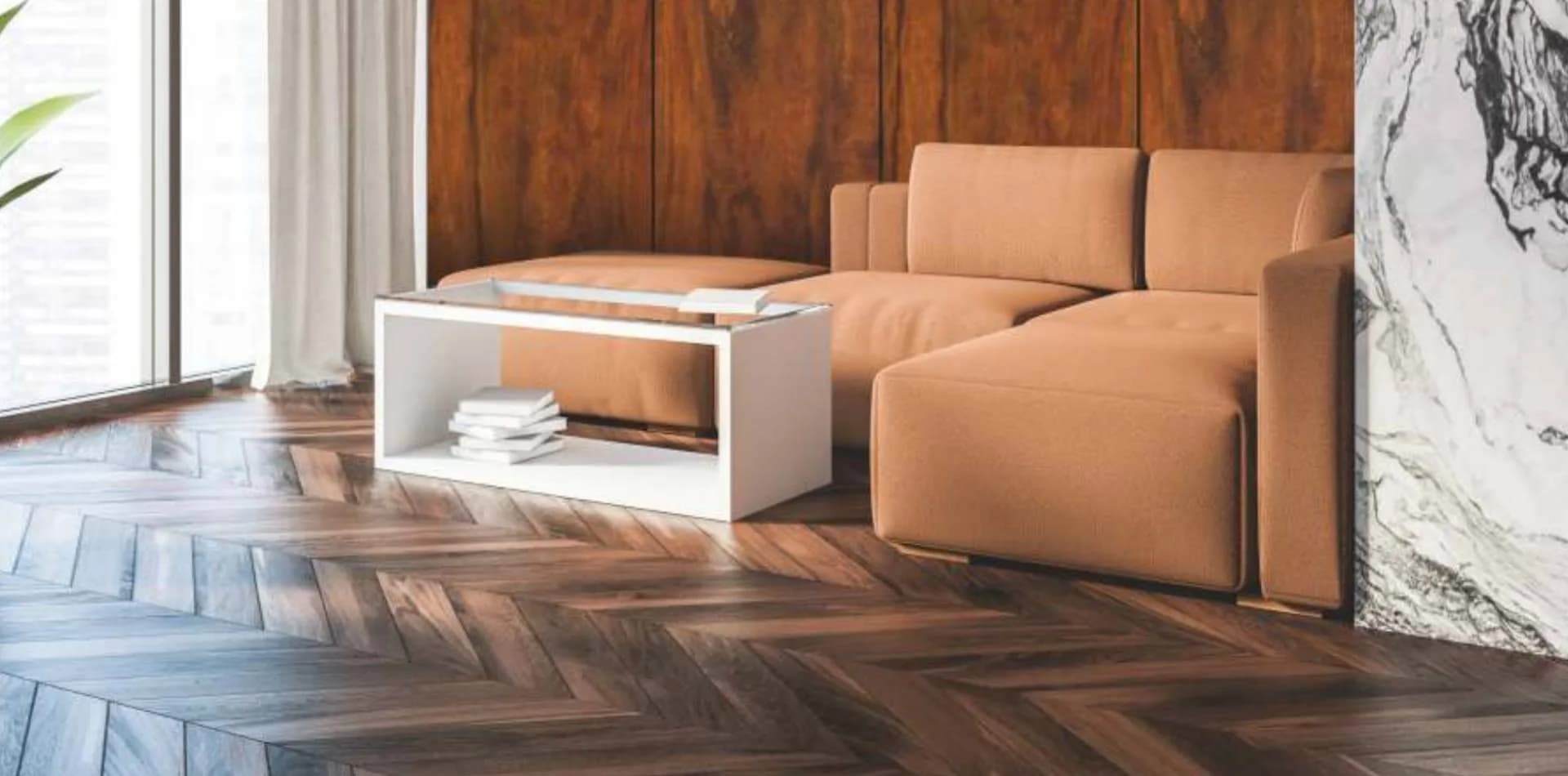 Herringbone wood floor in a living room with a tan sofa