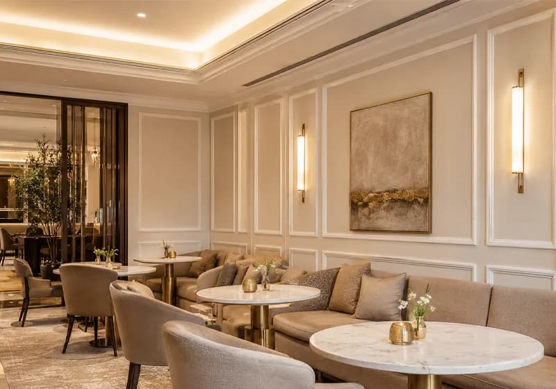 Hotel lounge with moulding panels along the wall and a framed painting