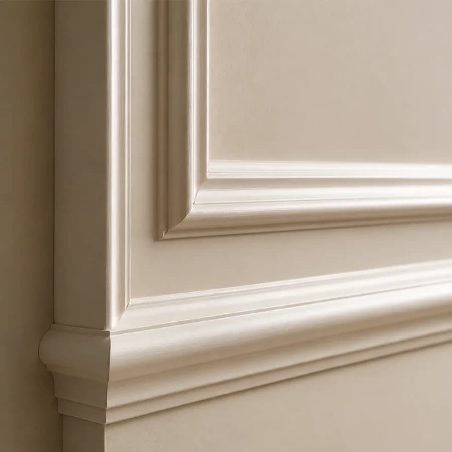 Close-up of a cream wall moulding profile with a stepped frame above a skirting board