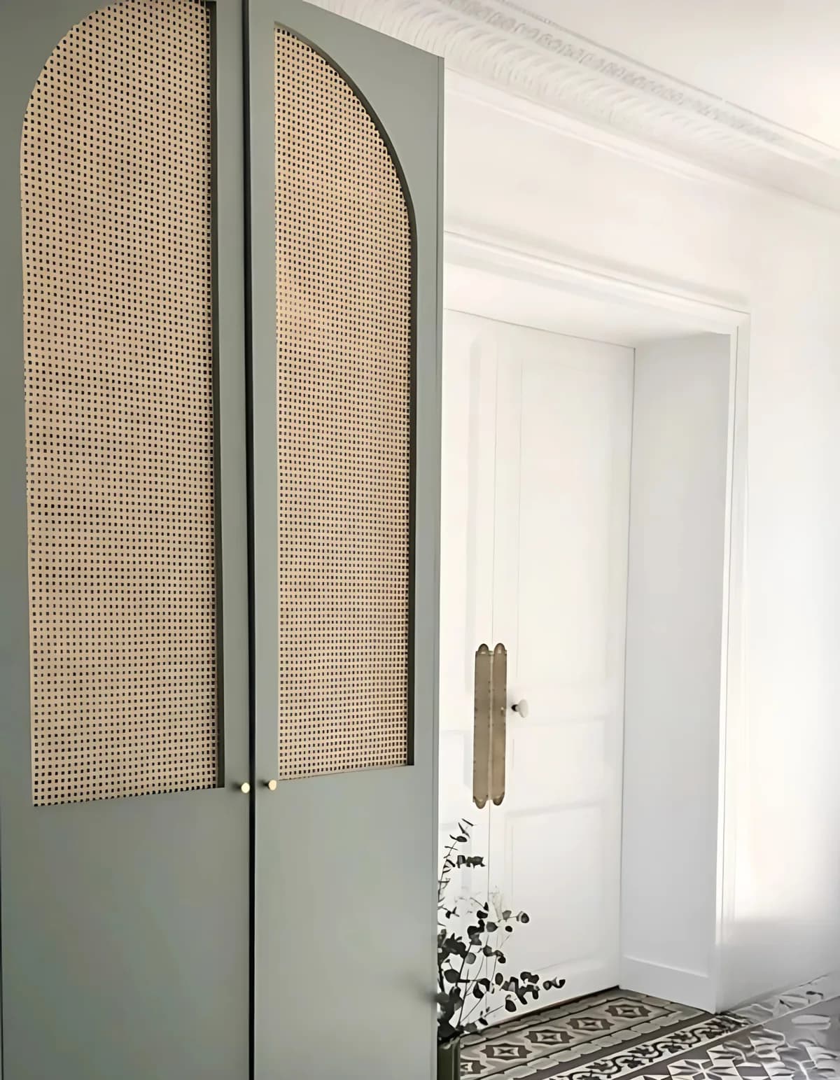 Sage-green arched wardrobe doors with cane webbing panels