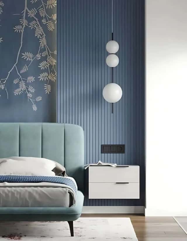 Bedroom with blue fluted wall panelling, an upholstered bed and a floating nightstand