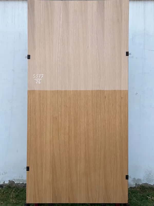 White oak veneer sheet with a pale raw upper half and a light tan finished lower half