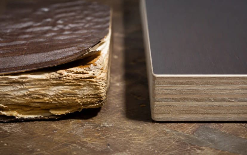Comparison of a swollen water-damaged plywood edge with peeling laminate beside a clean intact edge-banded plywood panel