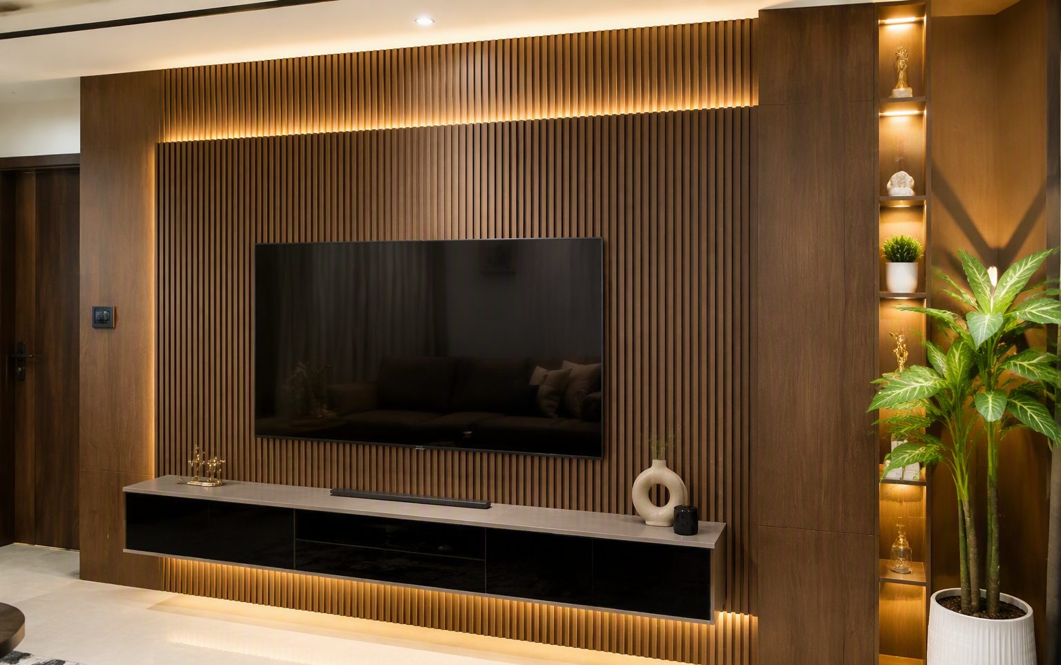 Modern Indian living room TV accent wall with walnut fluted WPC louvre panels and warm LED backlighting