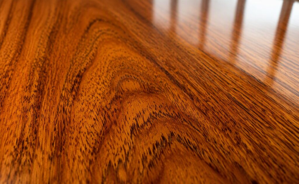 Cathedral figuring on natural teak veneer under a PU gloss coat